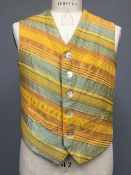 Mustard Yellow, Aqua Blue, Orange, Raw Silk, Brocade, Stripe, Five Shell Buttons at Center Front, Left Breast Pocket, Two Slanted Waist Pockets, Contrast Blue Silk Back with Adjustable Waist Belt. 